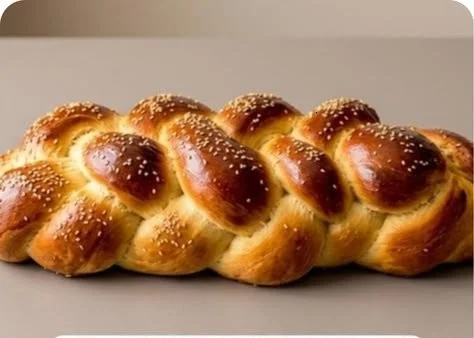Freshly baked challah bread with six-strand braid for a beautiful presentation.